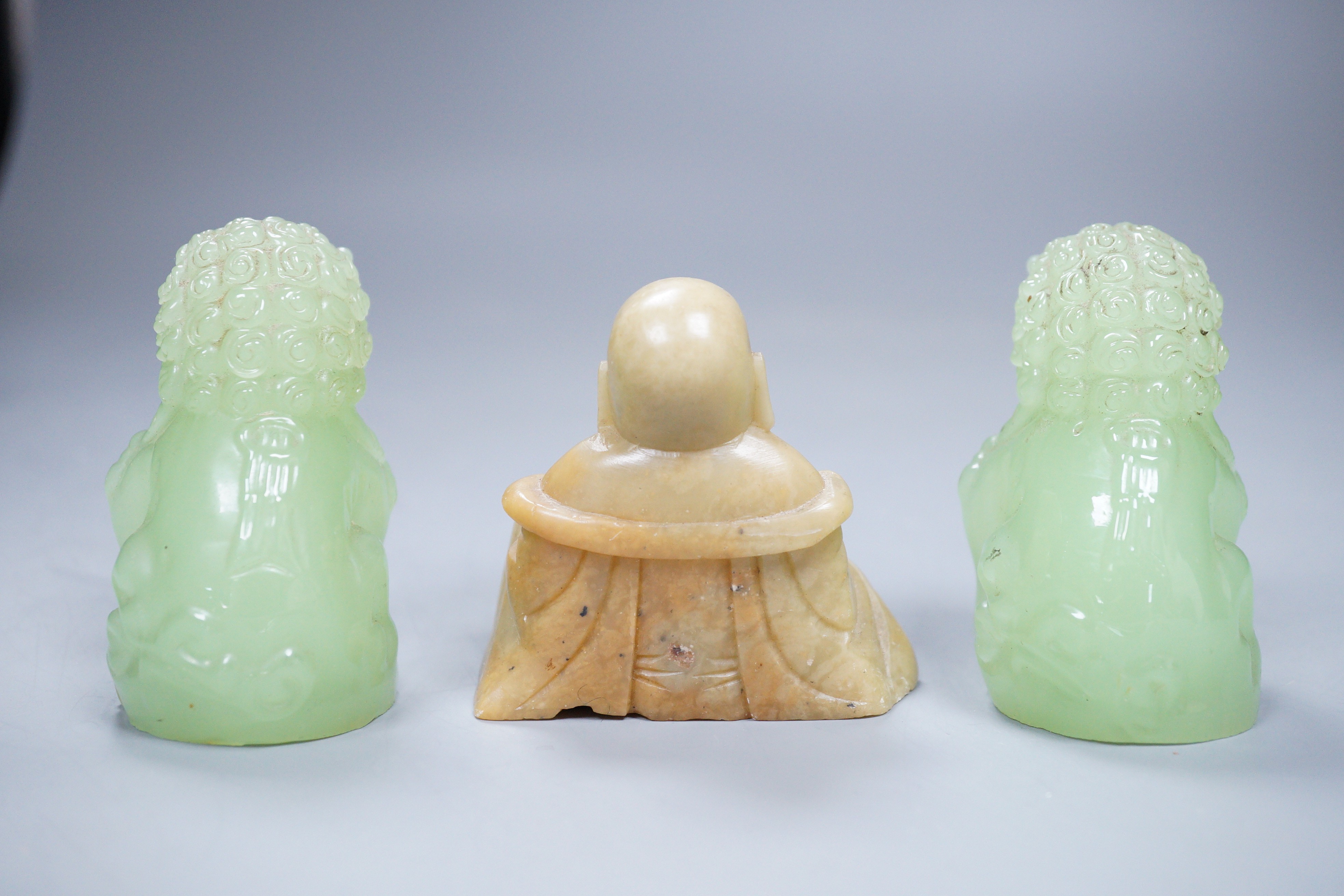 Two bowenite Buddhistic lions and a soapstone Buddha, 7cm